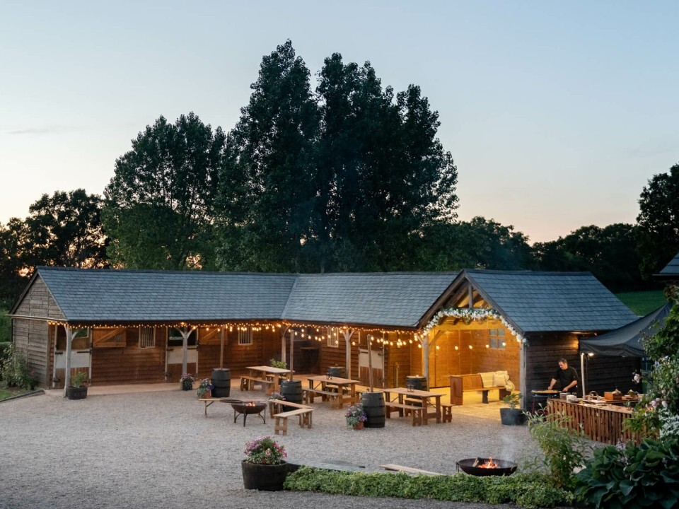 Exterior of Barn venue in the dark with lights 