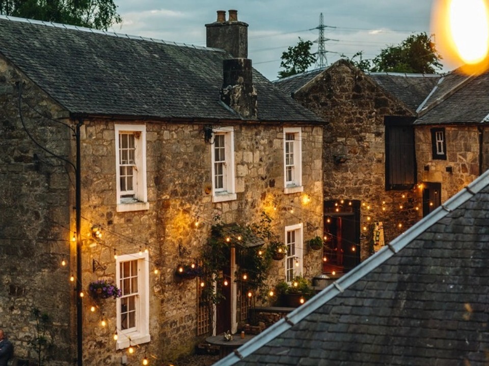 Exterior of Barn venue in the dark with lights 