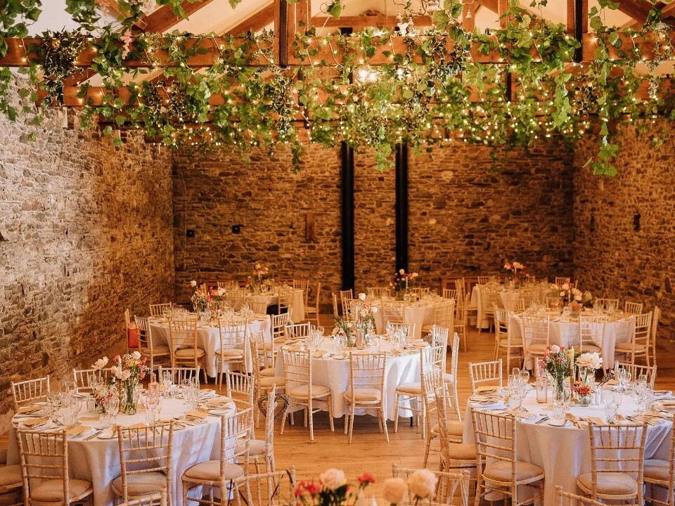 barn wedding venue wedding breakfast with brick, fairylight interior