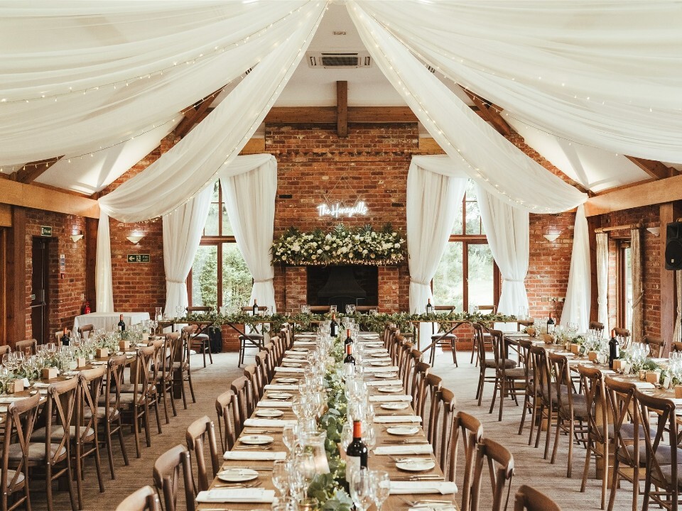 barn table set up with flowers and leaves