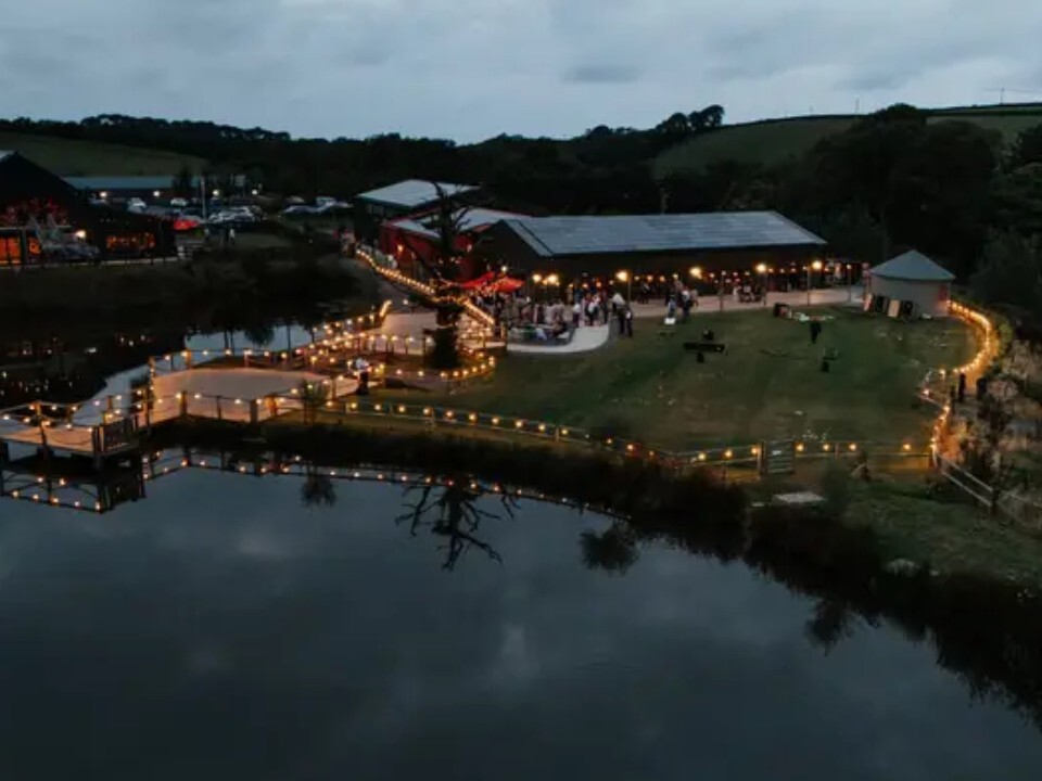Exterior of Barn venue in the dark with lights 