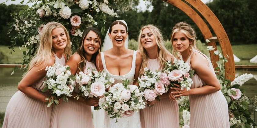 Bride and bridesmaids holding wedding bouquets