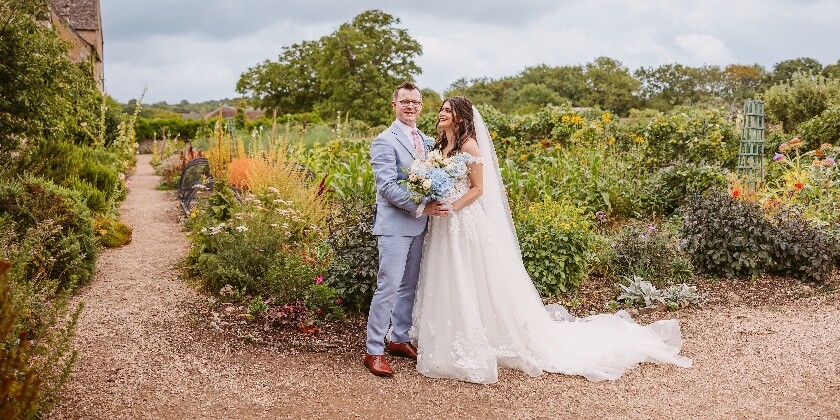 Bride and Groom on their wedding day in barn wedding venue in Cotswolds