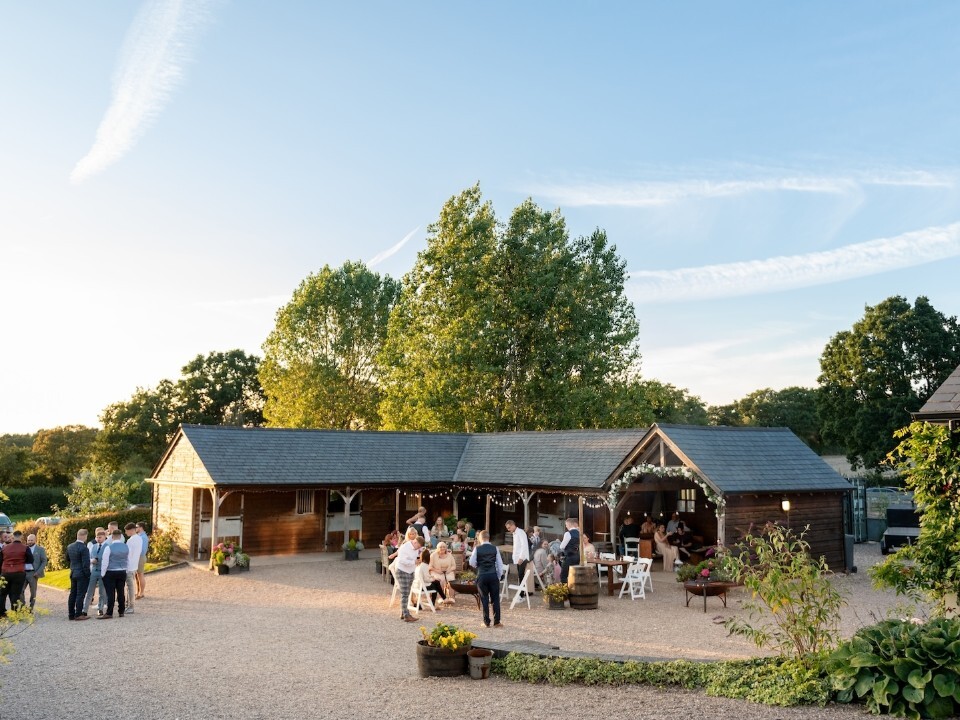 Exterior of Barn venue in daylight with guests