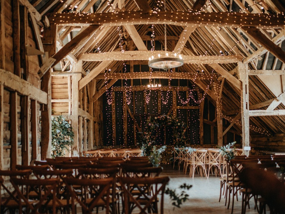 barn wedding venue with fairylights and wooden beams