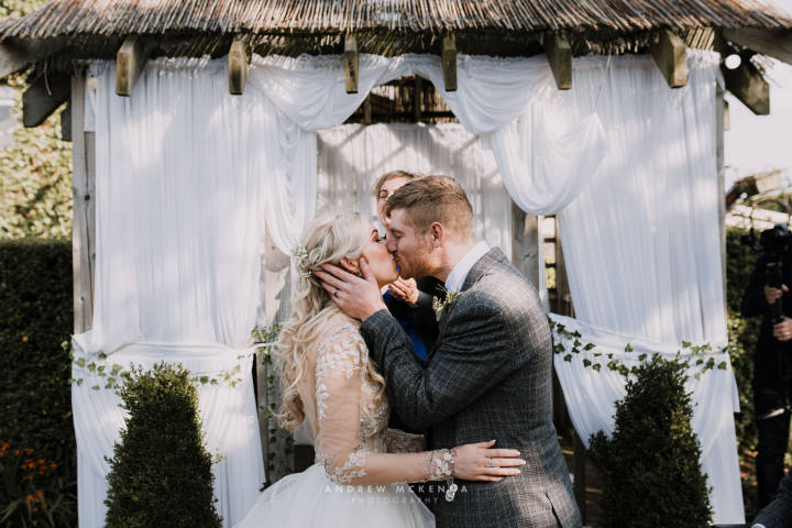 Couple Kissing After Vows at Hugh McCann's Wedding Venue