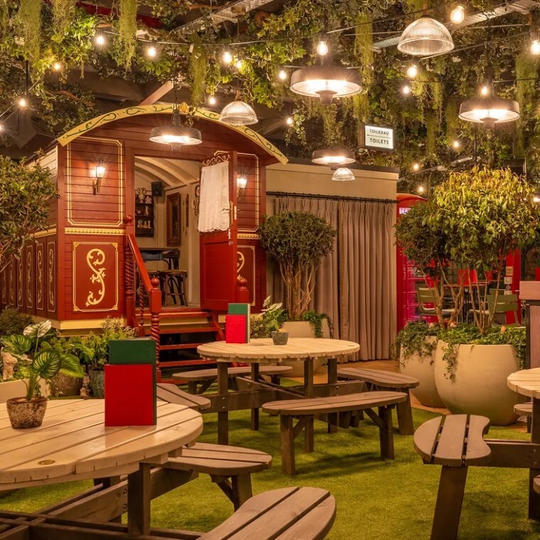 old wooden style caravan in a themed bar setting