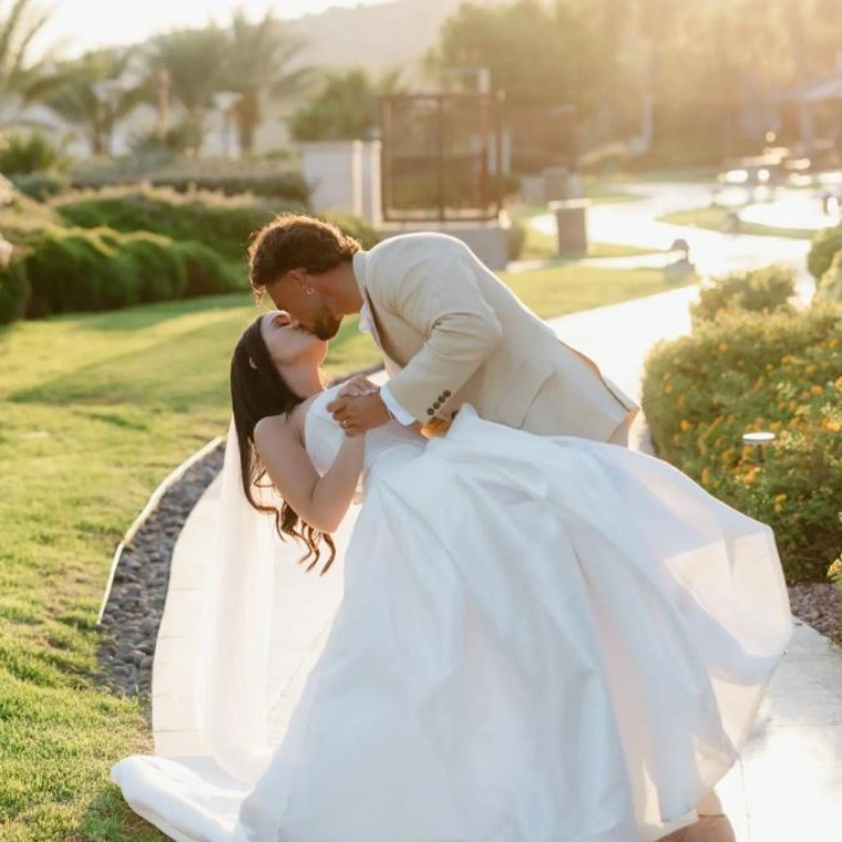 Bride and groom kiss at sunset at Amara, Cyprus