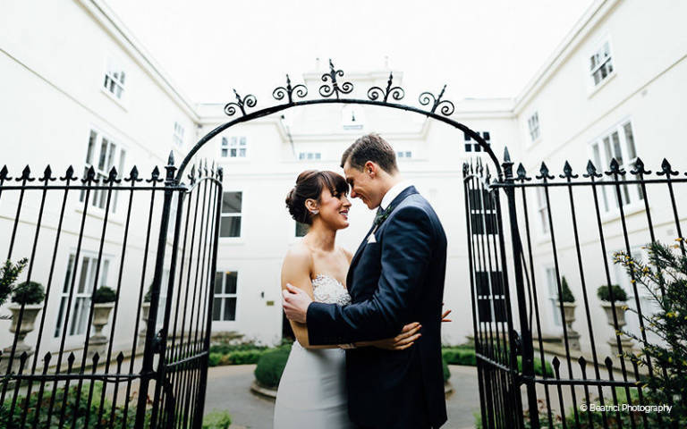 A couple take a moment under the archway at Morden Hall in London