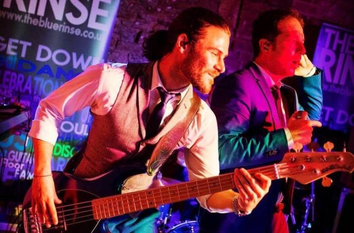 Man playing guitar from the Blue Rinse Live Band