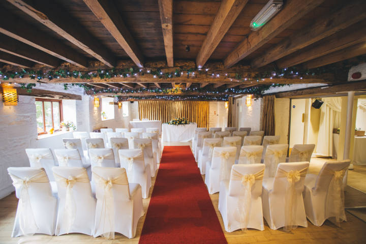Wedding ceremony with red carpet inside the venue