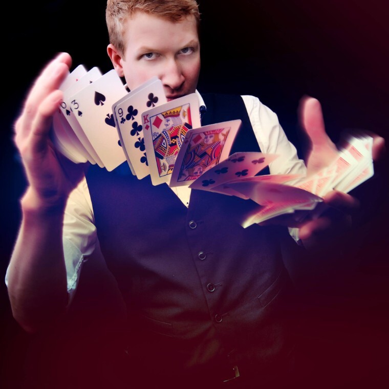 Alex Robertson from Arc Magic performing a trick with playing cards