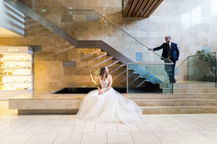 Bride Sat Next To Grand Staircasae at Slieve Donard Resort & Spa Venues