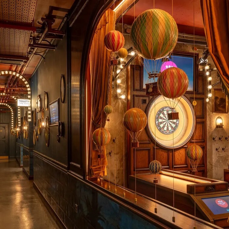 dartboard and hot air balloon decorations in a beautifully themed bar