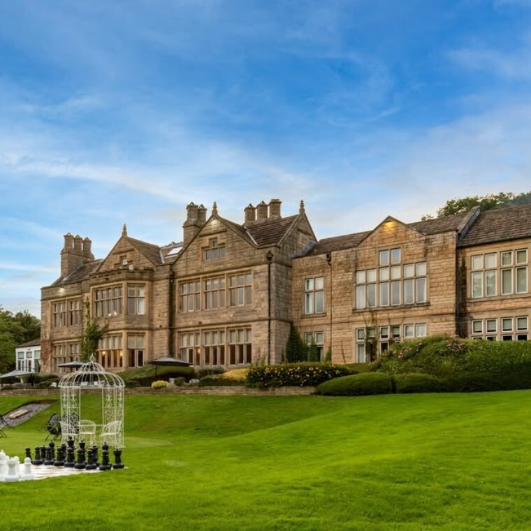 Hollins Hall Hotel & Spa from outside with outdoor chess on lawn.