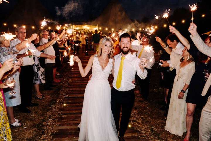 Bride and groom on a sparkler run