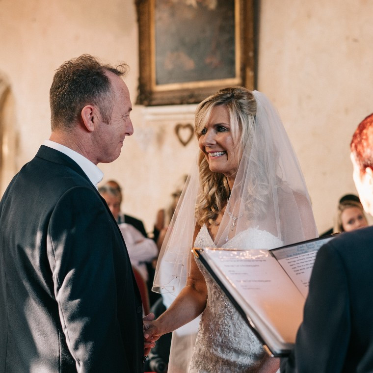 Bride and groom exchange vows during a wedding ceremony in the Great Hall