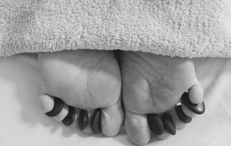 Hot stones between the toes