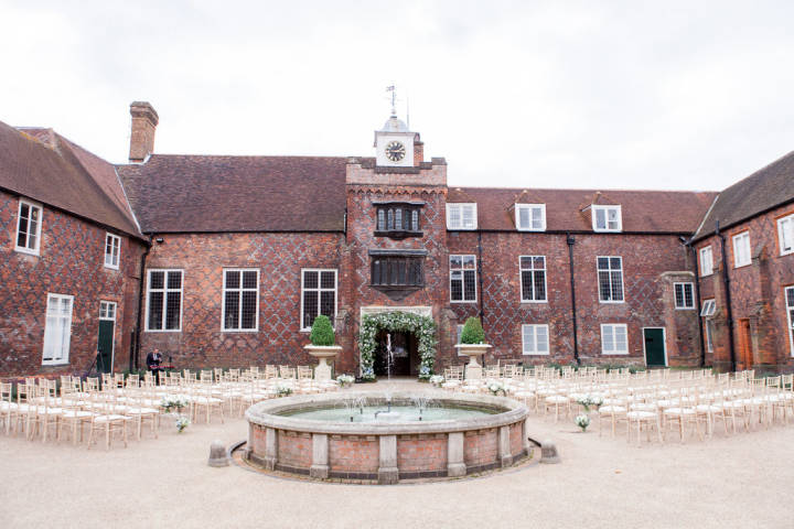 Outdoor wedding ceremony setting inside the courtyard of Fulham Palace