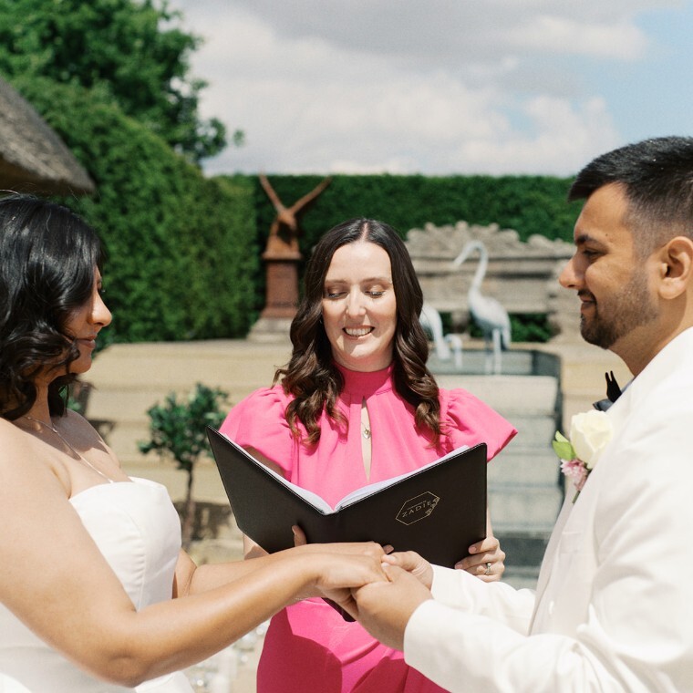 Wedding celebrant during ceremony with engaged couple