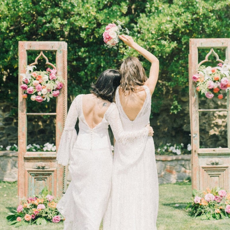 Bride and bride embracing on wedding day