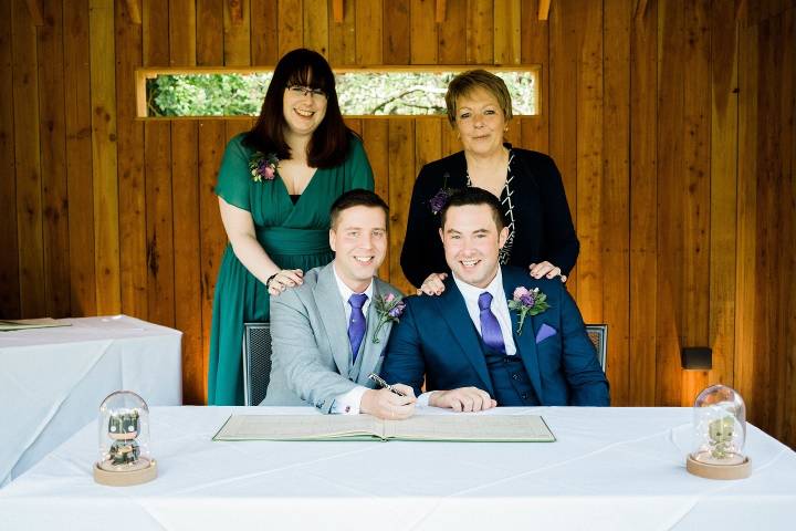Wedding couple sign the register during their wedding at Egypt Mill
