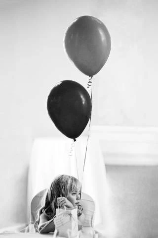 Flower girl with balloons at Danesfield House Wedding