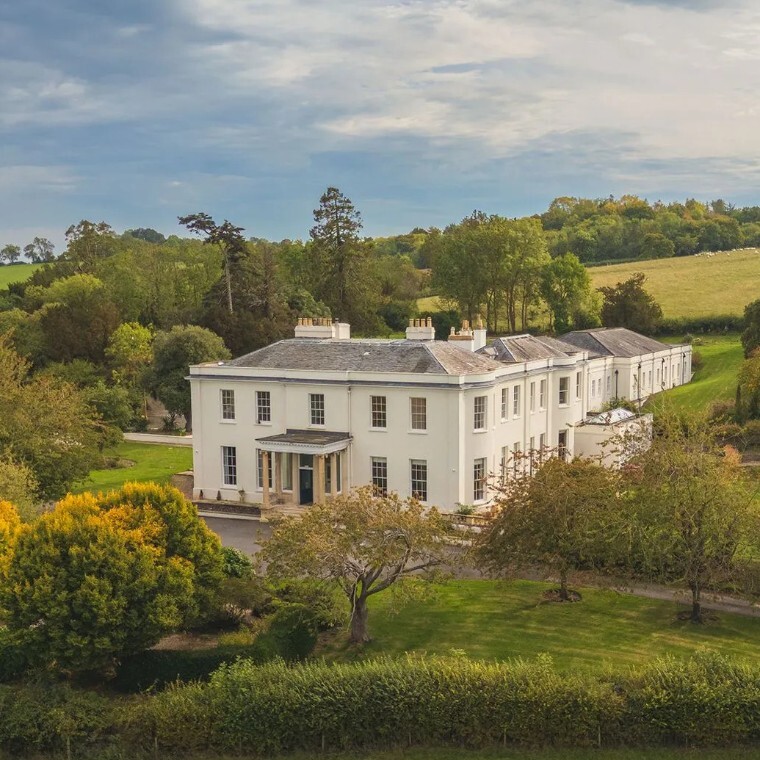 Henlade House wedding venue in Somerset, a grand white country house surrounded by rolling countryside, mature trees and landscaped gardens