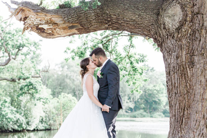 Bride and groom kissing at Stoke Place, Berkshire