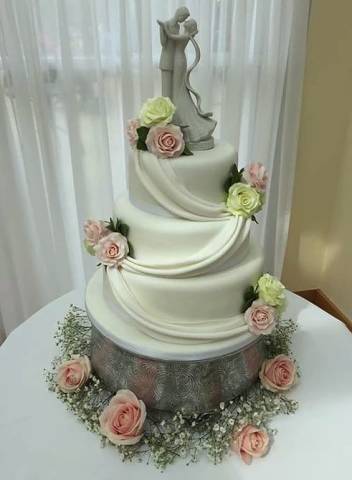 Traditional stacked wedding cake with couple topper
