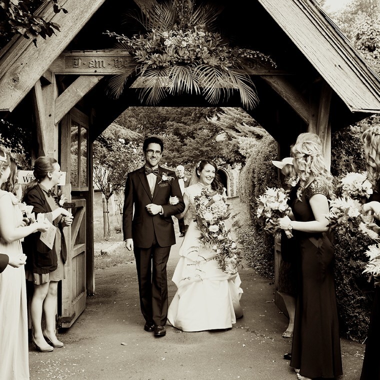 bride and groom with cascading floral bouquet just married.