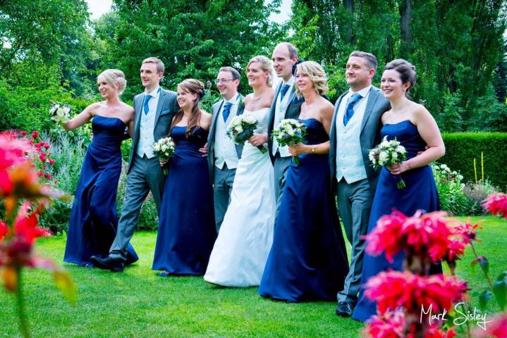 Bridal party walking through the gardens at The Odney Club in Buckinghamshire