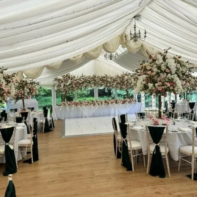 floral wedding venue including tables and dance floor 