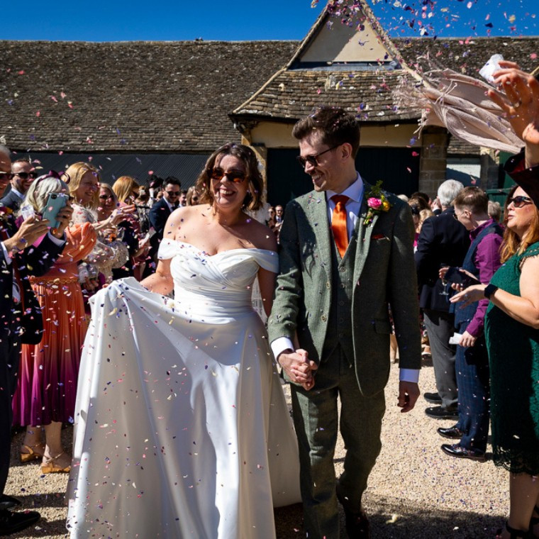 Confetti thrown over wedding couple as exiting the Wheat Barn