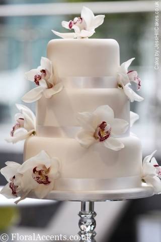 Fresh orchids provide a simply but stunning decoration for a wedding cake - by Floral Accents.Ca