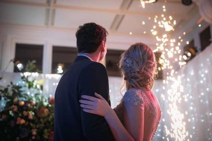 Bride and groom watching fire sparks