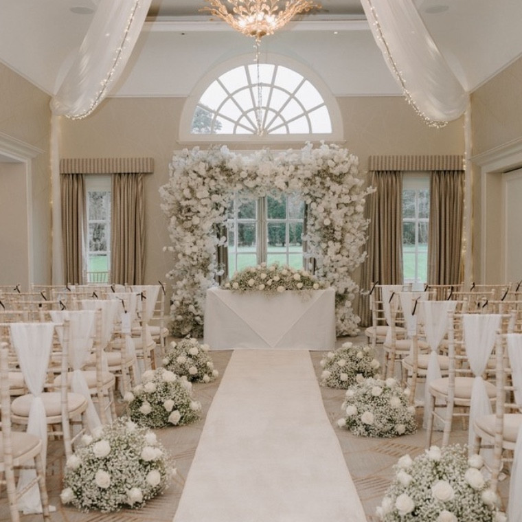 Luxury faux flower wedding arch in a ceremony 