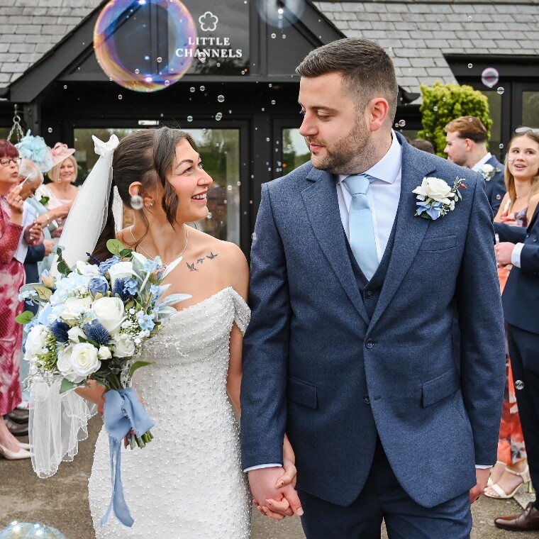 A happy newly married couple enjoying their bubble confetti moment 