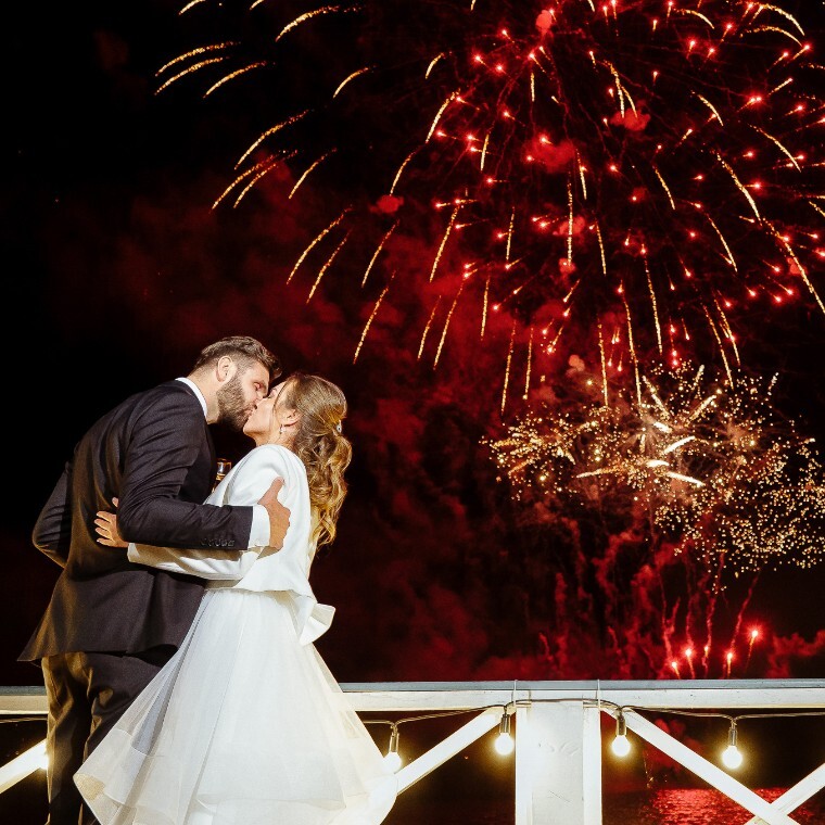 Bride and Groom kissing under fireworks by Cornwall Wedding Photographer Tanya Bogdan