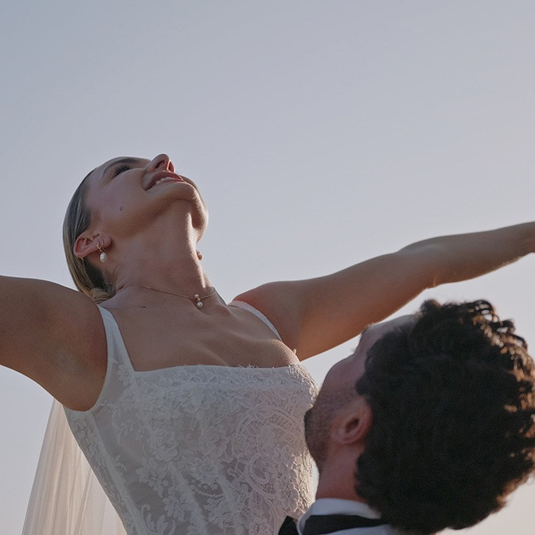 Bride laughing with joy during wedding ceremony, captured in a natural cinematic film still by Dean Sherwood Wedding Films, Hertfordshire wedding videographer.