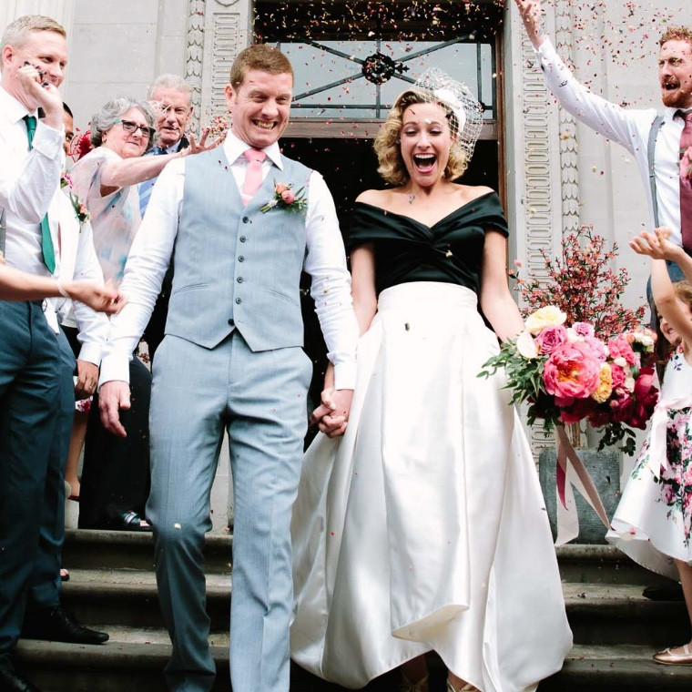 confetti being thrown at bride and groom at wedding in oxfordshire