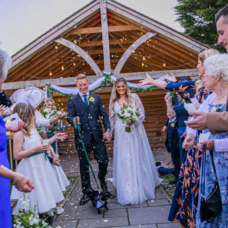 Bride and groom outdoor wedding ceremony confetti exit