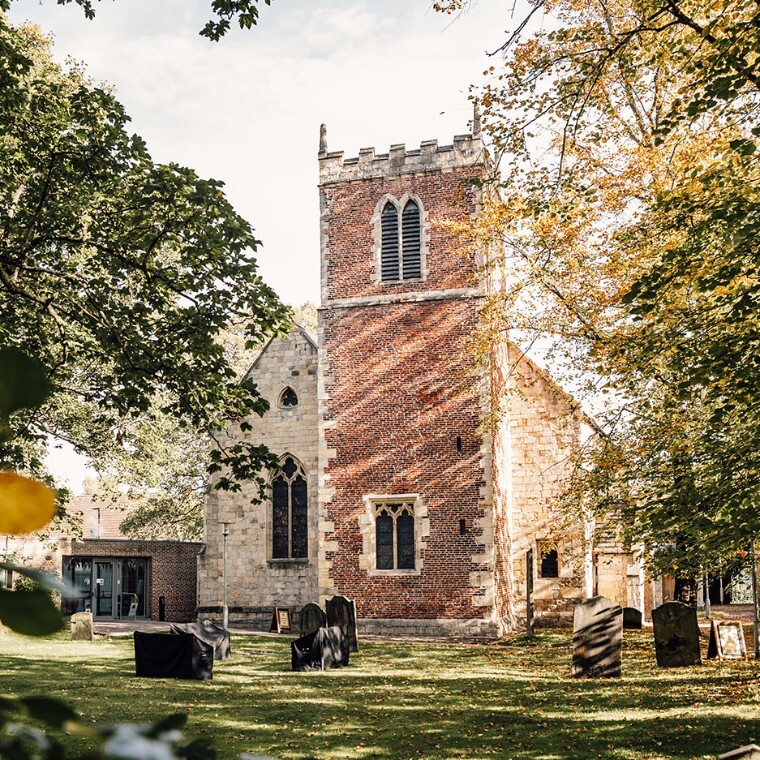 St. Margarets church with grass and green leafy trees