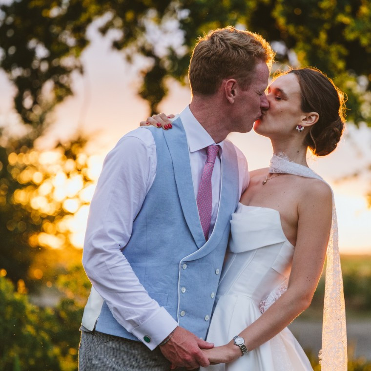 Bride and Groom Kiss in the Sunset
