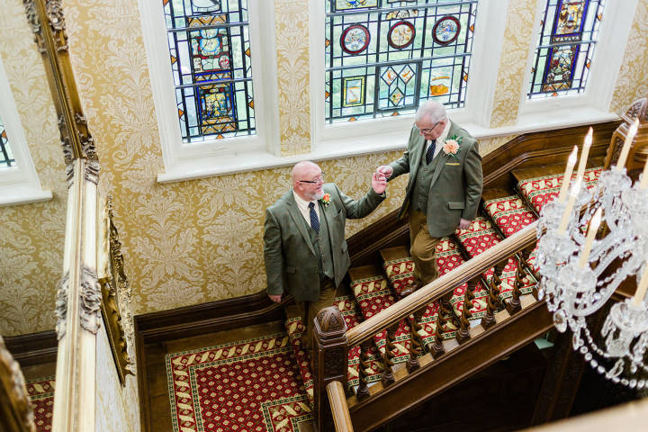 Grooms walking down the stairs at Kilworth House Hotel