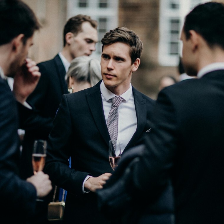 Groom and groomsmen wearing suits