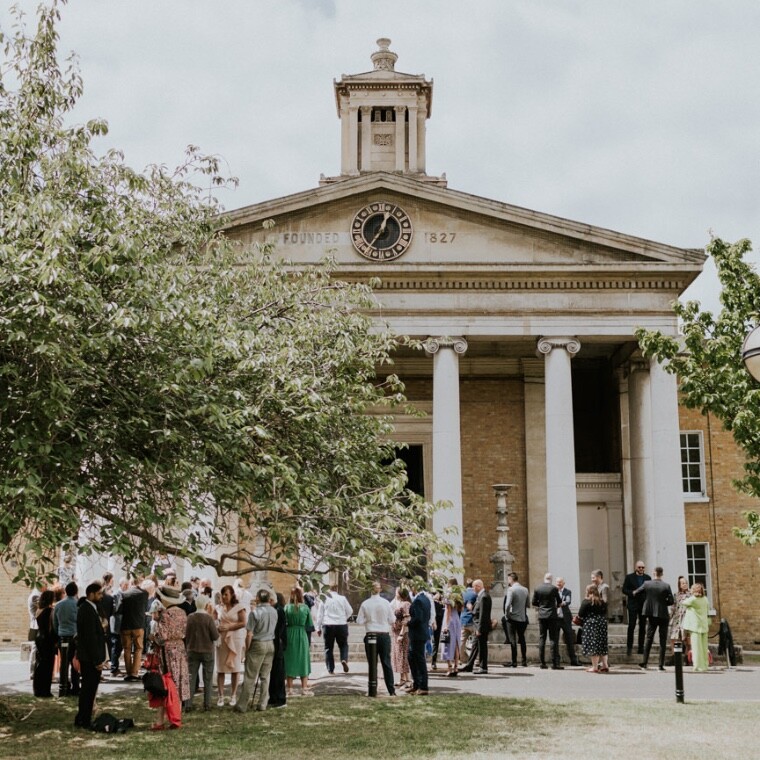 Guests enjoying post ceremony drinks outside the front of Asylum Chapel.