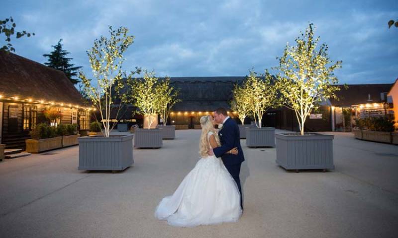 Couple Kissing Outside Channels Wedding Venue at Evening