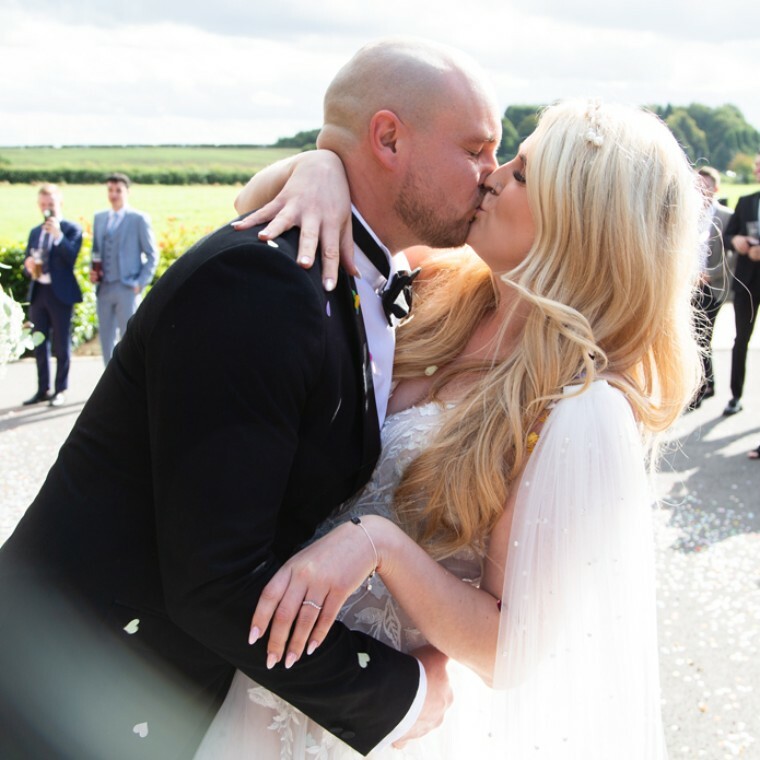 Couple kissing on their wedding day by Charlotte Elizabeth Photography