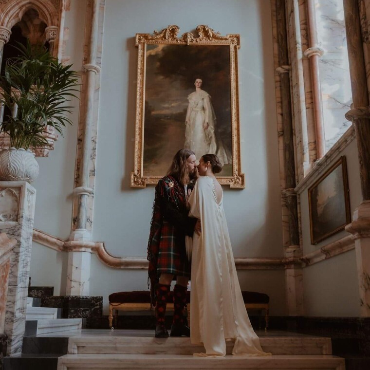wedding couple sharing a quiet moment on the stairs before being called into dinner
